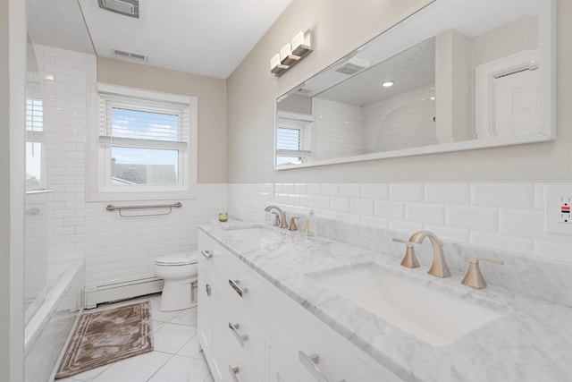bathroom featuring vanity, tile patterned floors, toilet, tile walls, and a baseboard radiator