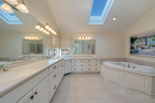 bathroom with lofted ceiling with skylight, double vanity, and a sink