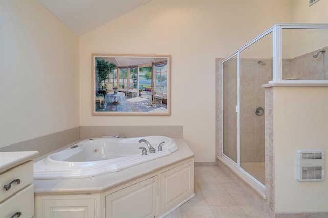 full bathroom featuring heating unit, lofted ceiling, a stall shower, tile patterned flooring, and a garden tub