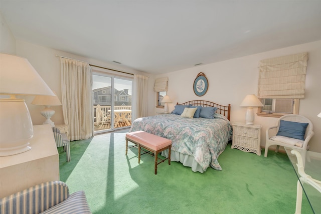 bedroom featuring access to outside, visible vents, and carpet floors