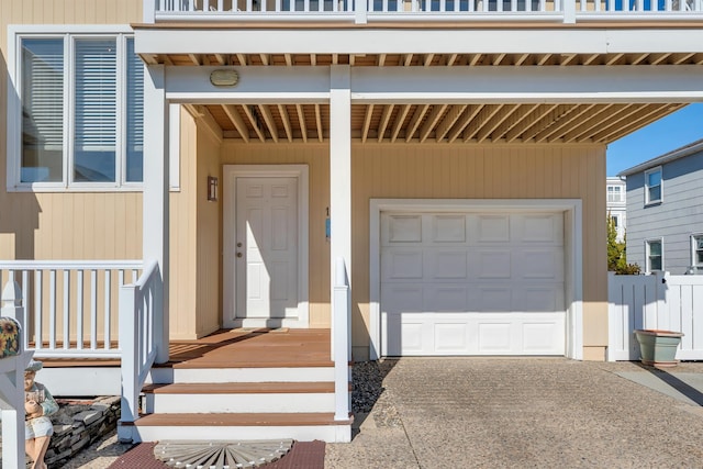 view of exterior entry with a garage and driveway