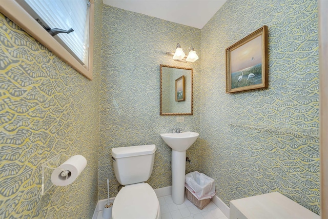 bathroom featuring lofted ceiling, toilet, and tile patterned flooring