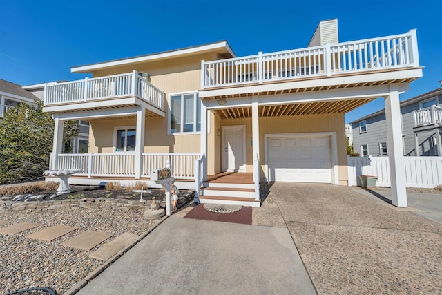 view of front facade with a porch, driveway, and a balcony