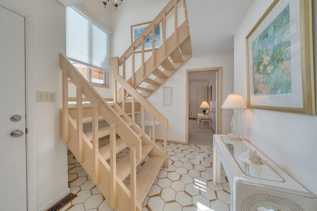 staircase with tile patterned flooring and visible vents