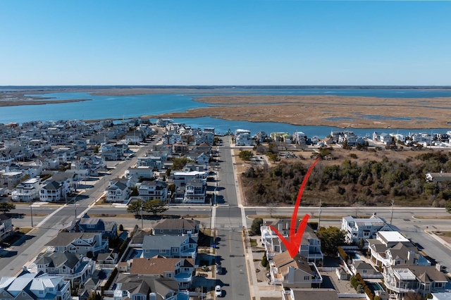 drone / aerial view featuring a residential view and a water view