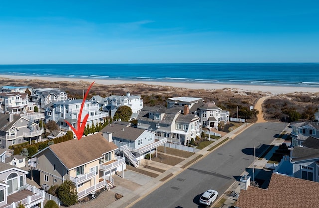 birds eye view of property featuring a residential view, a view of the beach, and a water view