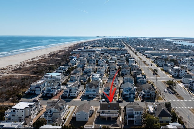 birds eye view of property with a residential view, a water view, and a view of the beach