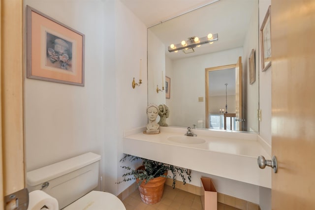 bathroom featuring toilet and a sink