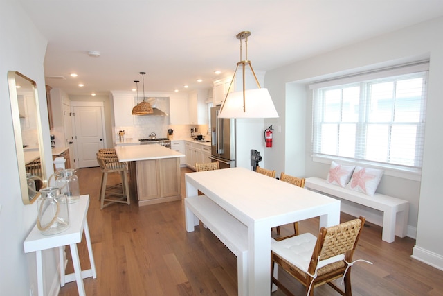 286 24th St Unit 286, Avalon, NJ 08202 - kitchen with tasteful backsplash, a kitchen island, a breakfast bar, high end refrigerator, and wood finished floors