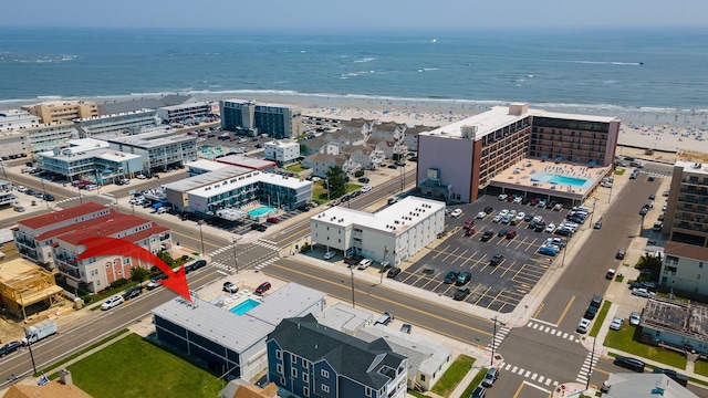 drone / aerial view with a beach view and a water view