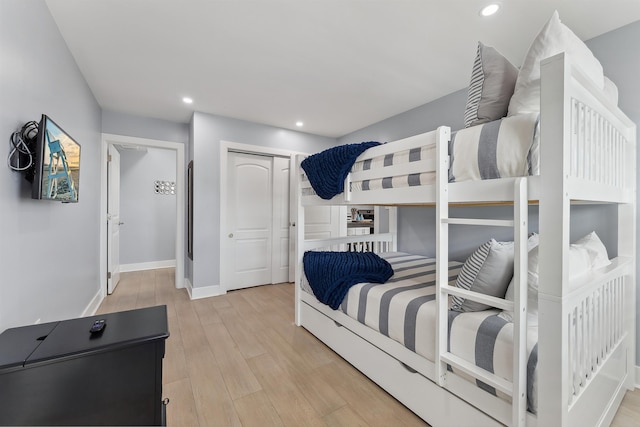 bedroom with a closet and light hardwood / wood-style flooring