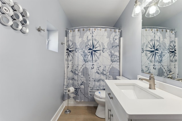 bathroom with vanity, toilet, curtained shower, and wood-type flooring