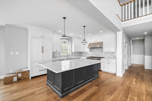 65 E 24th St, Avalon, NJ 08202 - kitchen featuring gas stove, under cabinet range hood, white cabinets, light countertops, and recessed lighting
