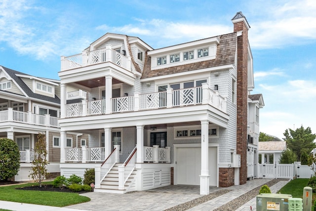 65 E 24th St, Avalon, NJ 08202 - view of front of home featuring a gate, an attached garage, a porch, and a balcony