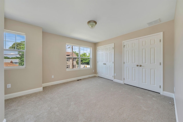 14 E New York Ave, Villas, NJ 08251 - unfurnished bedroom with multiple closets, multiple windows, and carpet