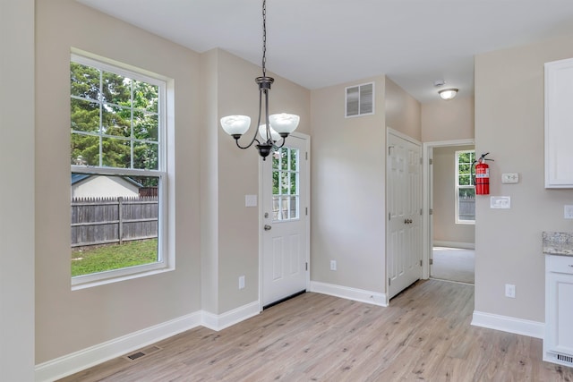 14 E New York Ave, Villas, NJ 08251 - foyer entrance featuring a chandelier, healthy amount of natural light, and light wood-type flooring
