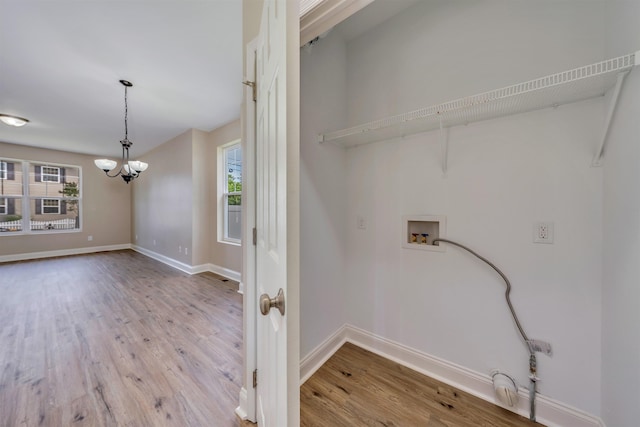 14 E New York Ave, Villas, NJ 08251 - laundry area featuring washer hookup, a chandelier, healthy amount of natural light, and wood finished floors