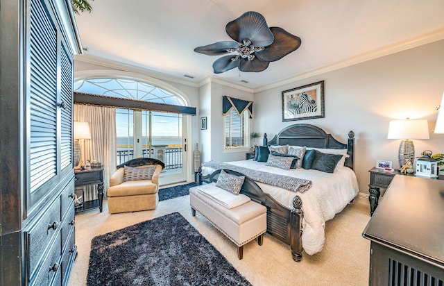 carpeted bedroom featuring access to outside, ceiling fan, crown molding, and a water view