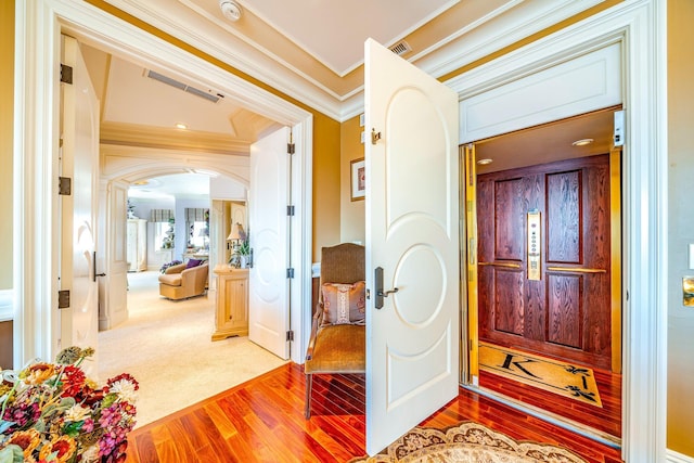 entrance foyer featuring wood-type flooring and ornamental molding