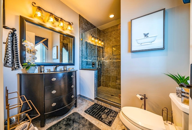 bathroom featuring an enclosed shower, vanity, toilet, and tile patterned floors