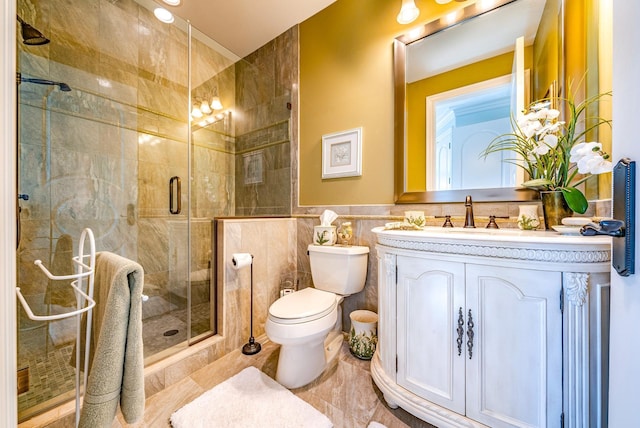 bathroom featuring walk in shower, vanity, toilet, and tile walls