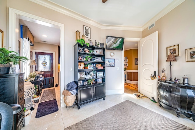 tiled entryway featuring ornamental molding