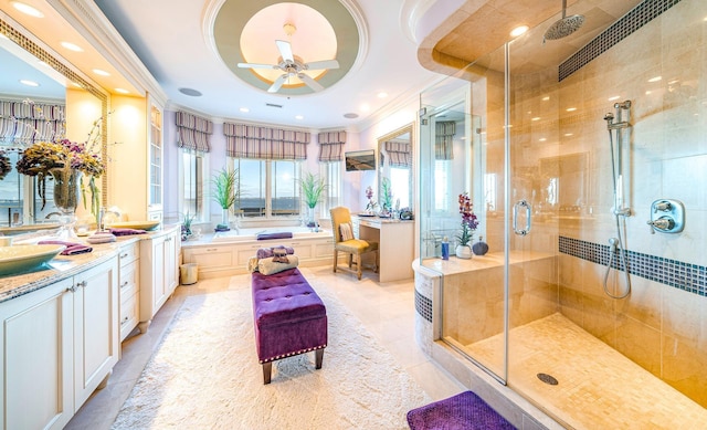 bathroom with ceiling fan, tile patterned flooring, separate shower and tub, vanity, and ornamental molding