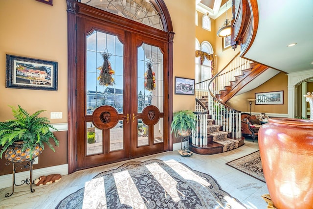 foyer with a high ceiling and french doors