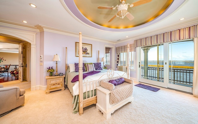 bedroom featuring ceiling fan, crown molding, a tray ceiling, light carpet, and access to outside