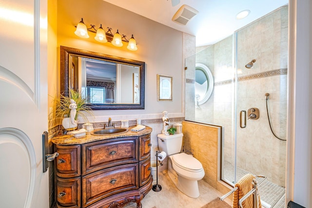 bathroom with vanity, tile patterned floors, toilet, tile walls, and walk in shower