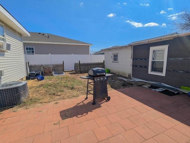 view of patio / terrace featuring area for grilling, fence, and central AC