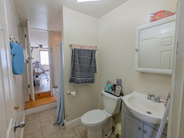 full bathroom with tile patterned floors, toilet, baseboards, walk in shower, and vanity