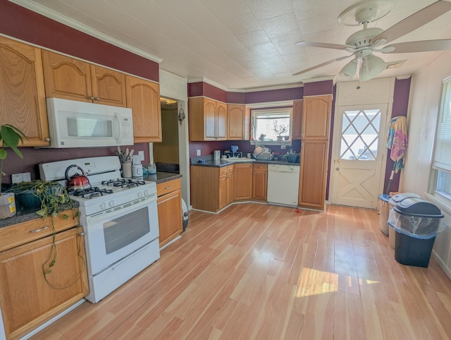 kitchen with dark countertops, light wood-style flooring, white appliances, and a ceiling fan