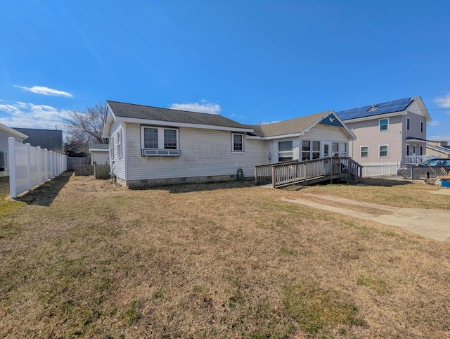 rear view of house featuring crawl space, a yard, and fence