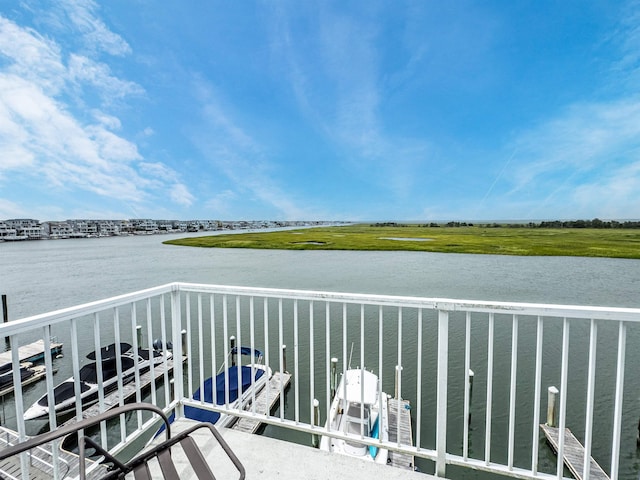 balcony featuring a water view and a dock