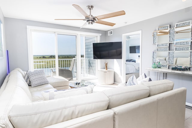 tiled living room with ceiling fan