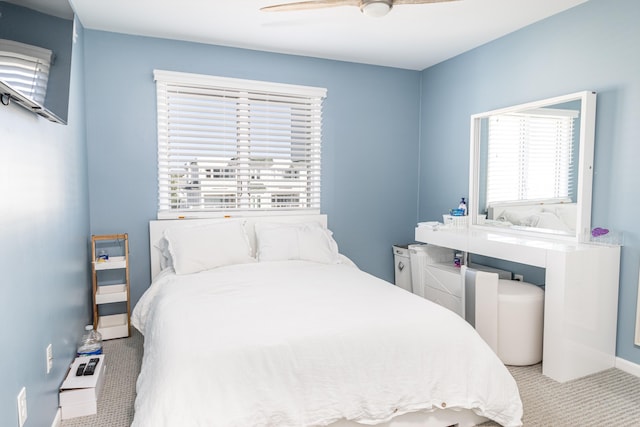 bedroom featuring light carpet and ceiling fan