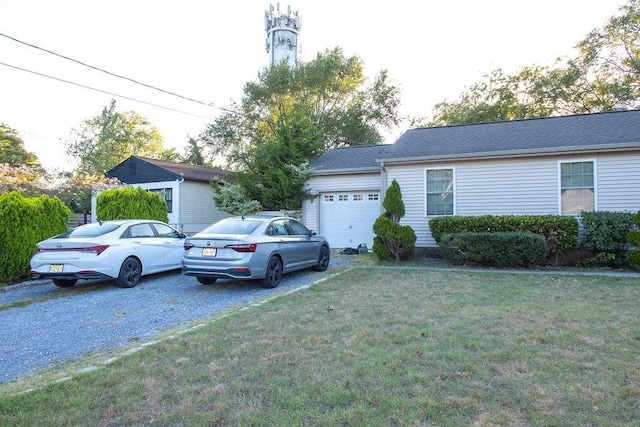 single story home featuring a front lawn and a garage