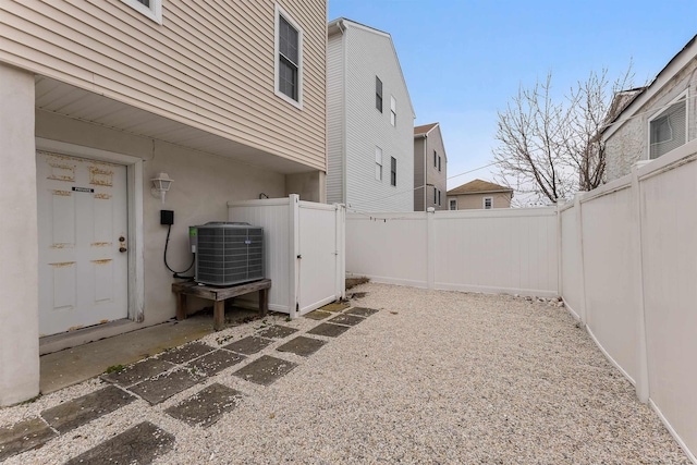 view of yard featuring fence and central air condition unit