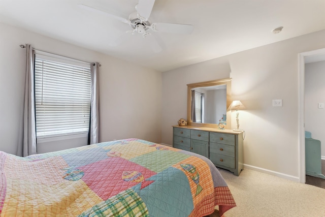 bedroom featuring a ceiling fan, light colored carpet, and baseboards