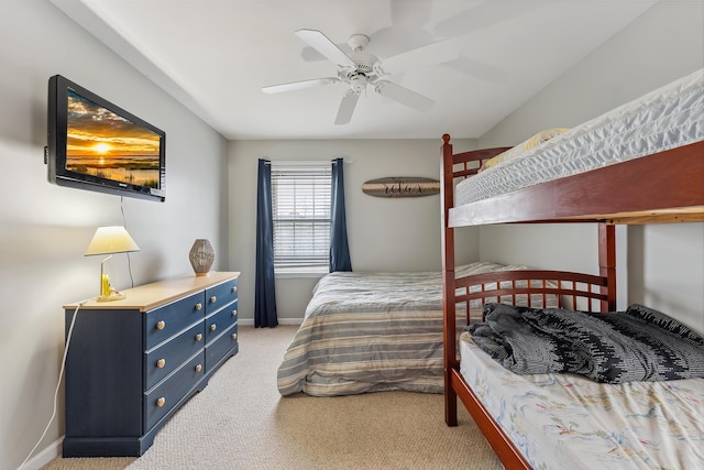 carpeted bedroom with ceiling fan and baseboards