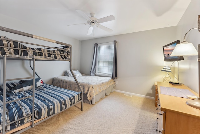 bedroom with ceiling fan, carpet flooring, and baseboards