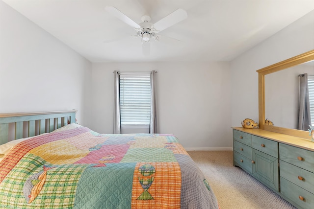 bedroom featuring light carpet, ceiling fan, and baseboards