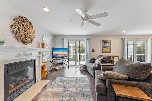 living room featuring a fireplace, wood finished floors, a ceiling fan, and recessed lighting