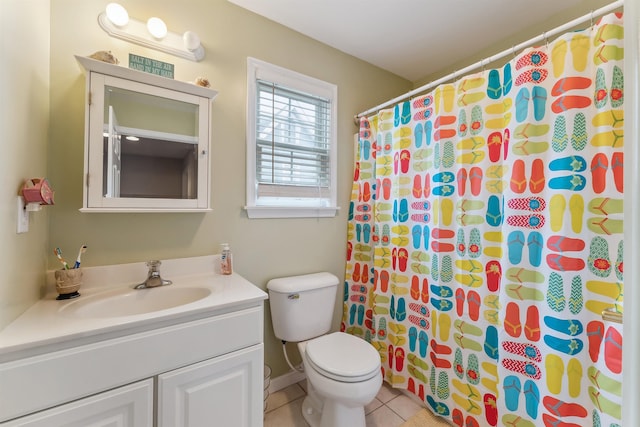 full bathroom with a shower with curtain, vanity, toilet, and tile patterned floors