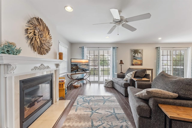 living room with ceiling fan, a fireplace, wood finished floors, and recessed lighting