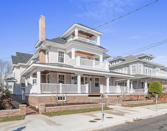 view of front of house featuring covered porch and a balcony