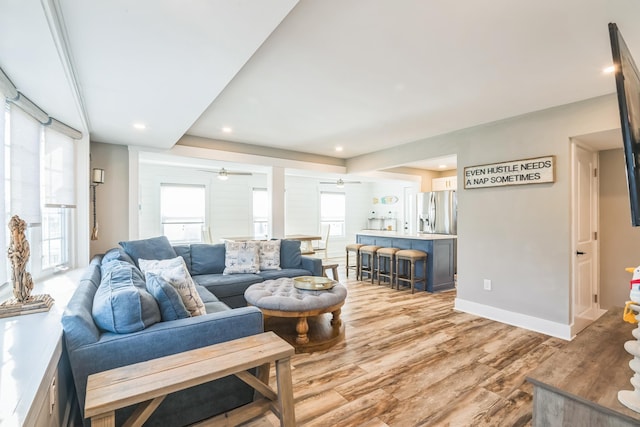 living room with ceiling fan and light hardwood / wood-style floors