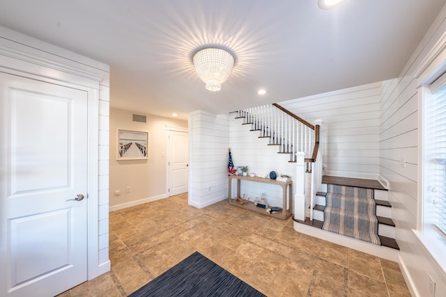 entrance foyer featuring stairway, a chandelier, recessed lighting, healthy amount of natural light, and baseboards