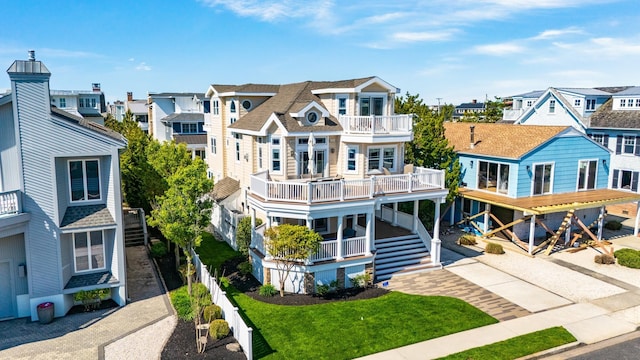 view of front of house with a balcony and a residential view